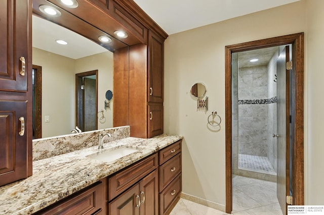 2564 County Road 12, Fremont, NE 68025 - bathroom featuring vanity, tiled shower, tile patterned floors, recessed lighting, and baseboards