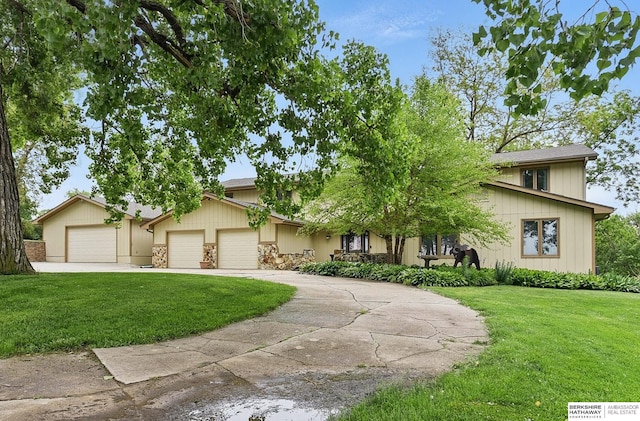 2564 County Road 12, Fremont, NE 68025 - view of front facade with a front yard, an attached garage, and concrete driveway