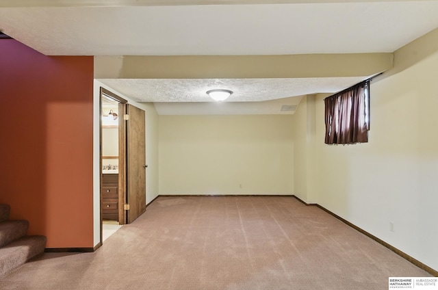 2564 County Road 12, Fremont, NE 68025 - finished below grade area featuring light carpet, baseboards, stairs, and a textured ceiling