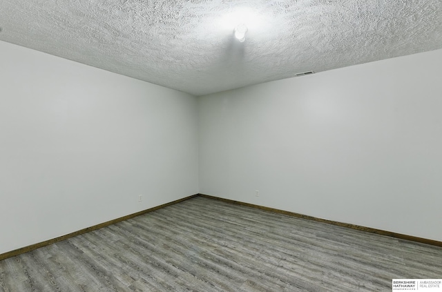 2564 County Road 12, Fremont, NE 68025 - unfurnished room featuring wood finished floors, baseboards, and a textured ceiling