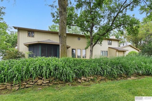 2564 County Road 12, Fremont, NE 68025 - back of property featuring a sunroom and a chimney