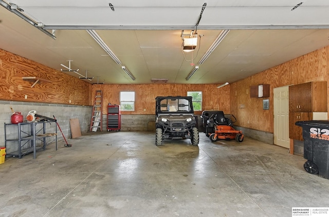 2564 County Road 12, Fremont, NE 68025 - garage featuring a garage door opener and wood walls