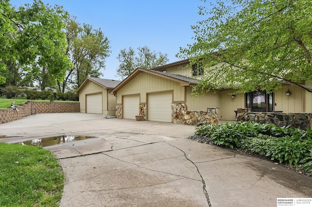 2564 County Road 12, Fremont, NE 68025 - view of front of home featuring a garage, driveway, and stone siding