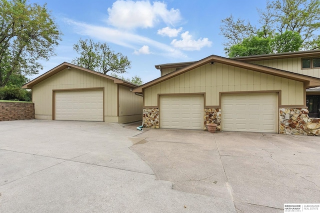 2564 County Road 12, Fremont, NE 68025 - view of front of property featuring stone siding, a detached garage, and an outbuilding