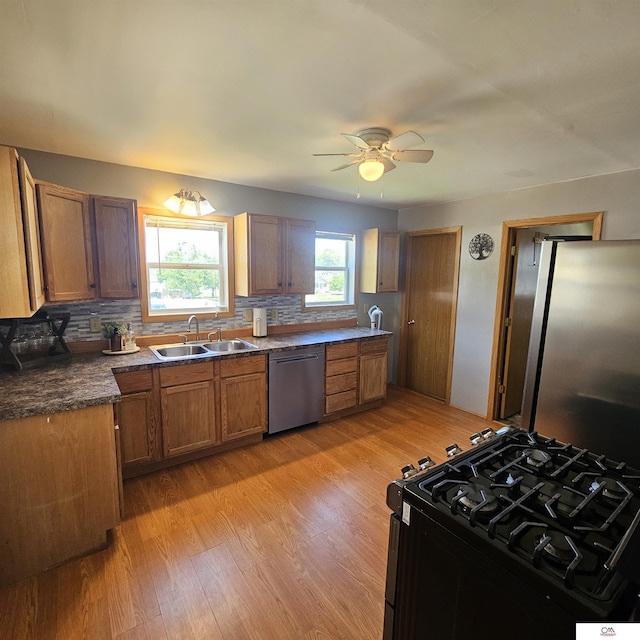 1119 H St, Fairbury, NE 68352 - kitchen with stainless steel appliances, ceiling fan, tasteful backsplash, and light wood-style flooring
