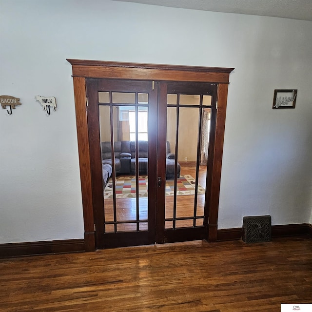 1119 H St, Fairbury, NE 68352 - detailed view of wood finished floors, baseboards, and french doors