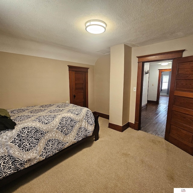 1119 H St, Fairbury, NE 68352 - bedroom featuring carpet, baseboards, and a textured ceiling