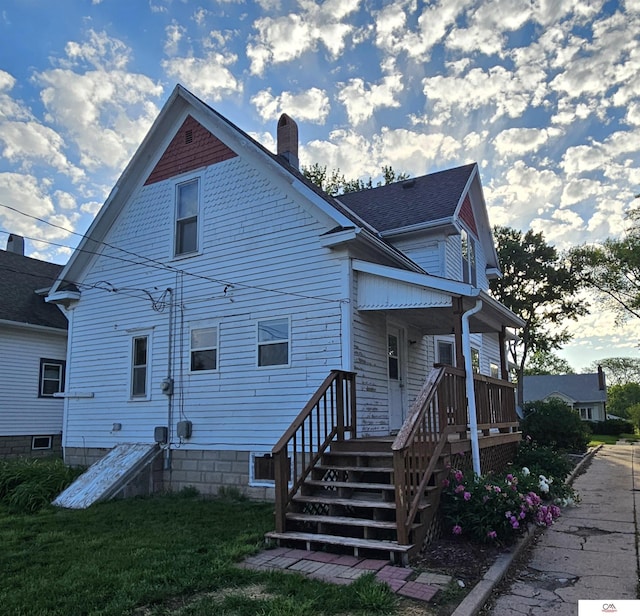 1119 H St, Fairbury, NE 68352 - rear view of house with a chimney