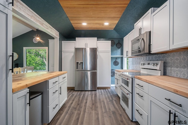 13055 Brookside Dr, Bellevue, NE 68123 - kitchen featuring butcher block countertops, appliances with stainless steel finishes, lofted ceiling, white cabinetry, and dark wood-style flooring