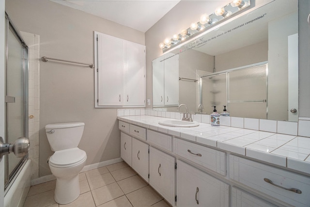 13055 Brookside Dr, Bellevue, NE 68123 - bathroom with vanity, toilet, tile patterned flooring, combined bath / shower with glass door, and baseboards