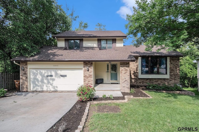 13055 Brookside Dr, Bellevue, NE 68123 - tri-level home featuring concrete driveway and brick siding