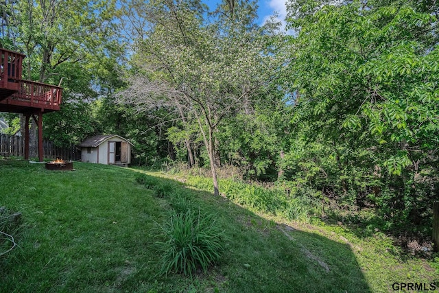 13055 Brookside Dr, Bellevue, NE 68123 - view of yard featuring a deck and a fire pit