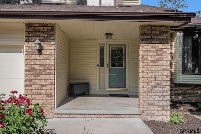 13055 Brookside Dr, Bellevue, NE 68123 - entrance to property featuring brick siding, covered porch, and a shingled roof