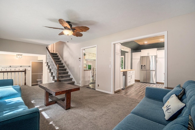 13055 Brookside Dr, Bellevue, NE 68123 - living room featuring stairs, a ceiling fan, wine cooler, carpet flooring, and baseboards