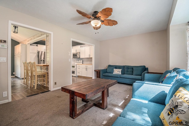 13055 Brookside Dr, Bellevue, NE 68123 - living room featuring ceiling fan, carpet, and baseboards