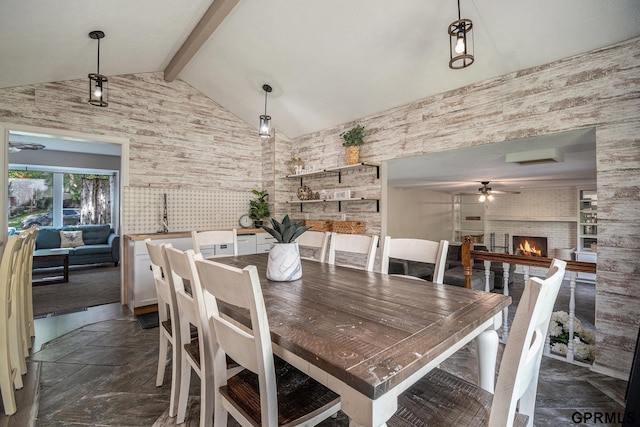 13055 Brookside Dr, Bellevue, NE 68123 - dining space featuring ceiling fan, a fireplace, and wallpapered walls