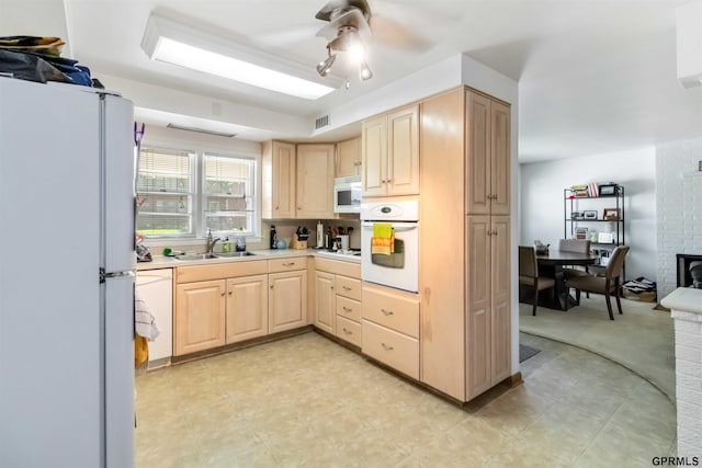 2206 N 56th St, Omaha, NE 68104 - kitchen featuring light brown cabinets, white appliances, ceiling fan, light countertops, and a sink