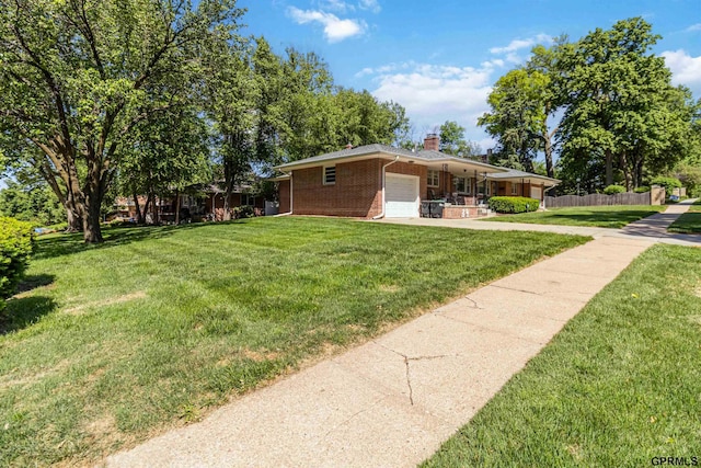 2206 N 56th St, Omaha, NE 68104 - view of yard featuring a garage, concrete driveway, and covered porch
