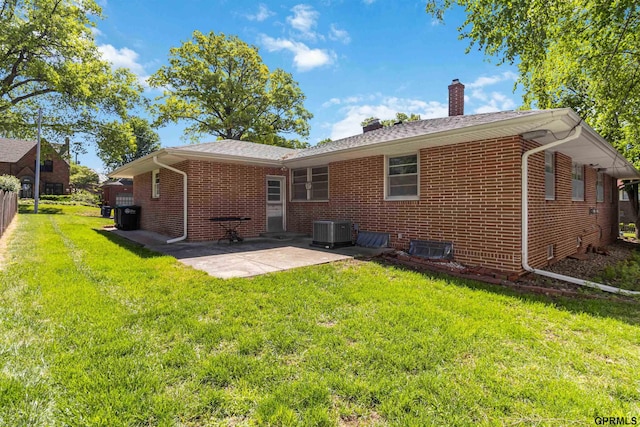 2206 N 56th St, Omaha, NE 68104 - back of house with a chimney, cooling unit, brick siding, and a patio area