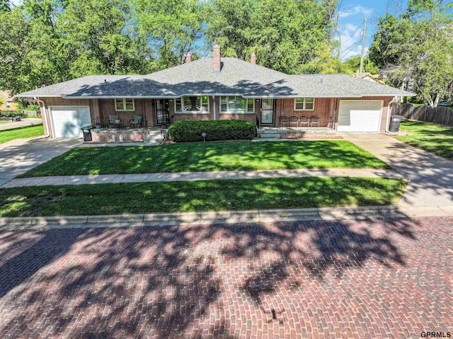 2206 N 56th St, Omaha, NE 68104 - ranch-style house featuring an attached garage, concrete driveway, and brick siding