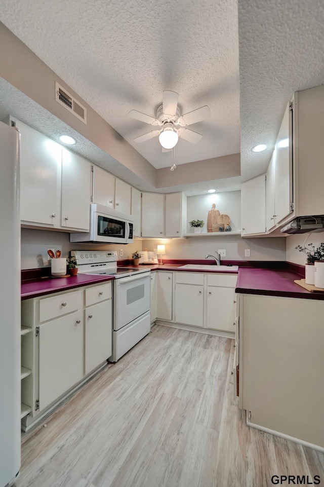 1625 Granada Ln, Lincoln, NE 68528 - kitchen with white appliances, open shelves, a sink, dark countertops, and a textured ceiling