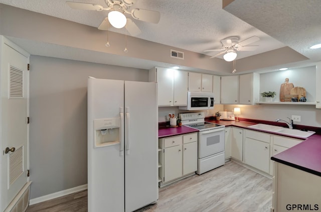 1625 Granada Ln, Lincoln, NE 68528 - kitchen featuring white appliances, a sink, ceiling fan, a textured ceiling, and dark countertops
