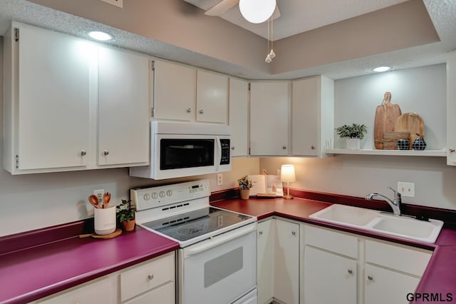 1625 Granada Ln, Lincoln, NE 68528 - kitchen with white appliances, a sink, white cabinets, and recessed lighting