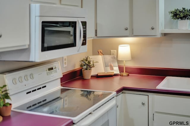 1625 Granada Ln, Lincoln, NE 68528 - kitchen featuring white appliances and white cabinets