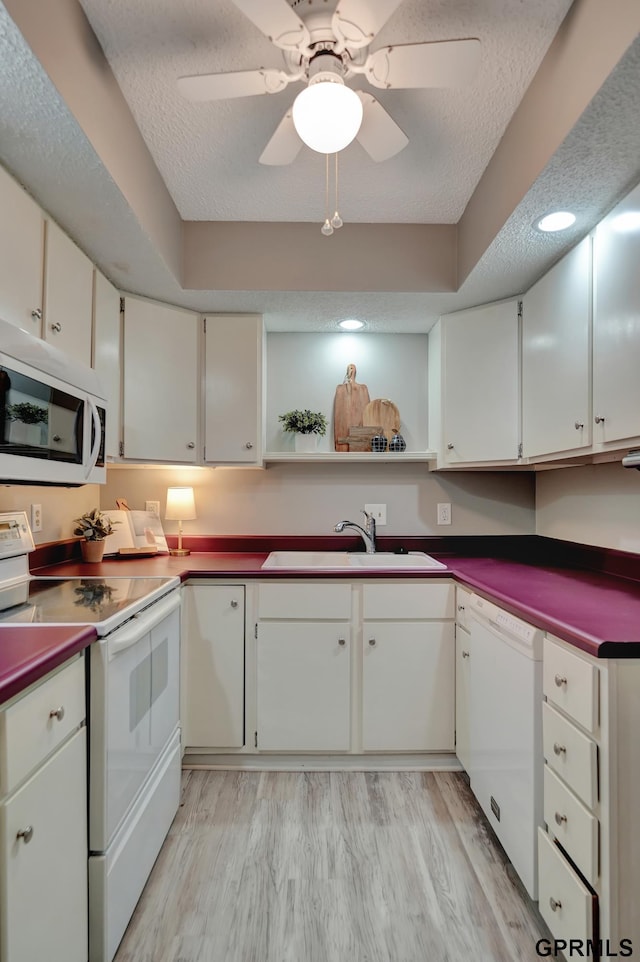 1625 Granada Ln, Lincoln, NE 68528 - kitchen featuring white appliances, a sink, open shelves, light wood finished floors, and dark countertops