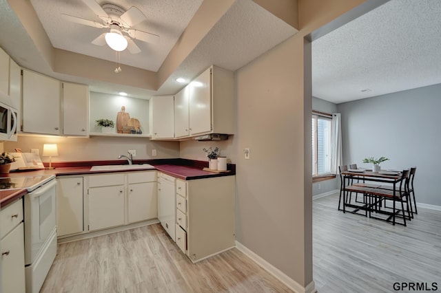 1625 Granada Ln, Lincoln, NE 68528 - kitchen featuring white appliances, a sink, open shelves, light wood-style flooring, and a textured ceiling