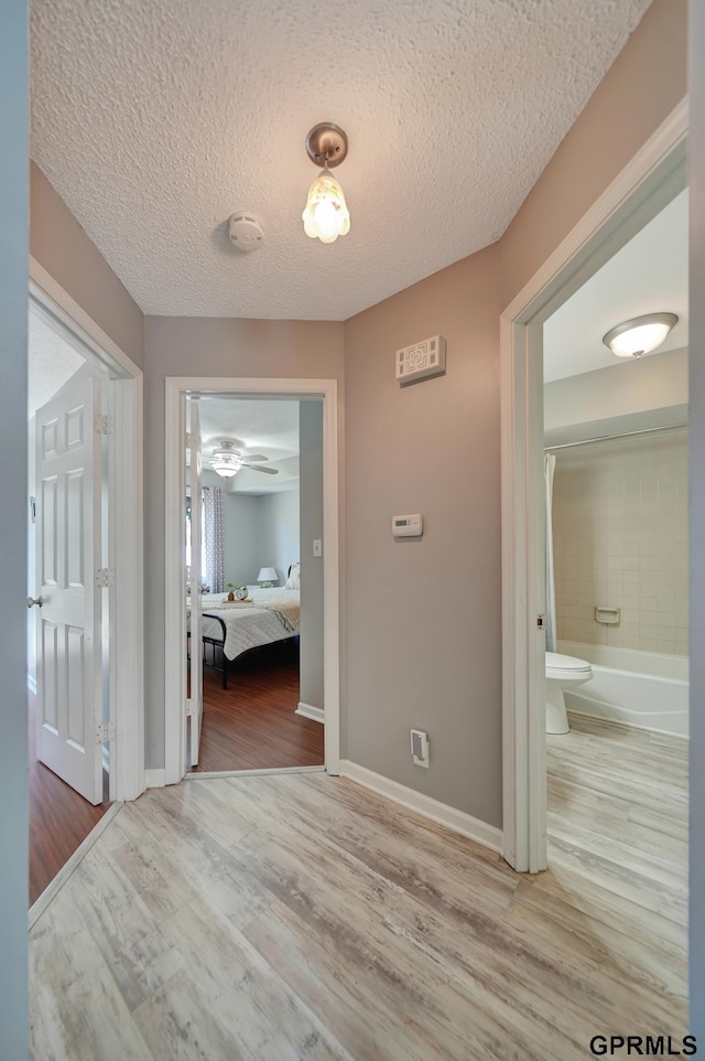 1625 Granada Ln, Lincoln, NE 68528 - corridor featuring wood finished floors, a textured ceiling, and baseboards