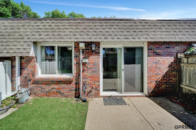 1625 Granada Ln, Lincoln, NE 68528 - doorway to property featuring a shingled roof and brick siding