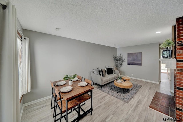 1625 Granada Ln, Lincoln, NE 68528 - living area with a textured ceiling, wood finished floors, baseboards, a brick fireplace, and recessed lighting