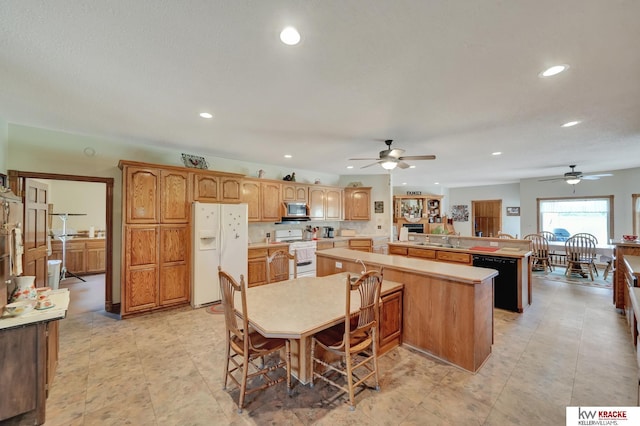 40798 US Highway 6, Cambridge, NE 69022 - kitchen featuring white appliances, ceiling fan, recessed lighting, a center island, and a sink