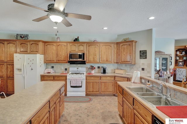 40798 US Highway 6, Cambridge, NE 69022 - kitchen with white appliances, a sink, light countertops, backsplash, and a ceiling fan
