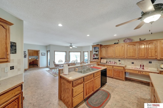 40798 US Highway 6, Cambridge, NE 69022 - kitchen featuring ceiling fan, dishwasher, a sink, a kitchen island with sink, and backsplash