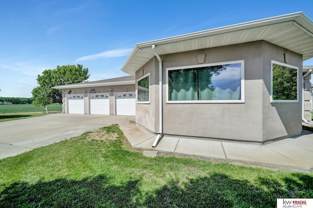 40798 US Highway 6, Cambridge, NE 69022 - view of home's exterior featuring stucco siding and a lawn