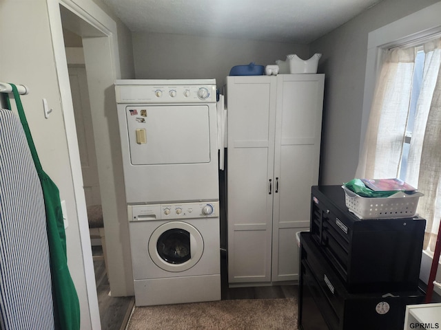 1211 D St, Fairbury, NE 68352 - laundry room featuring stacked washing machine and dryer, plenty of natural light, and wood finished floors
