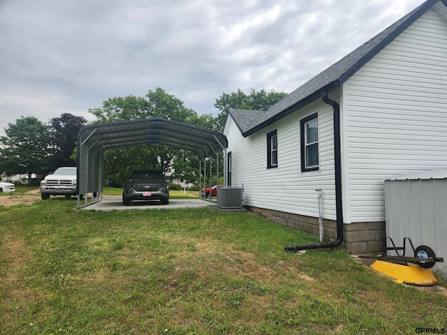 1211 D St, Fairbury, NE 68352 - view of grassy yard with central AC and a detached carport