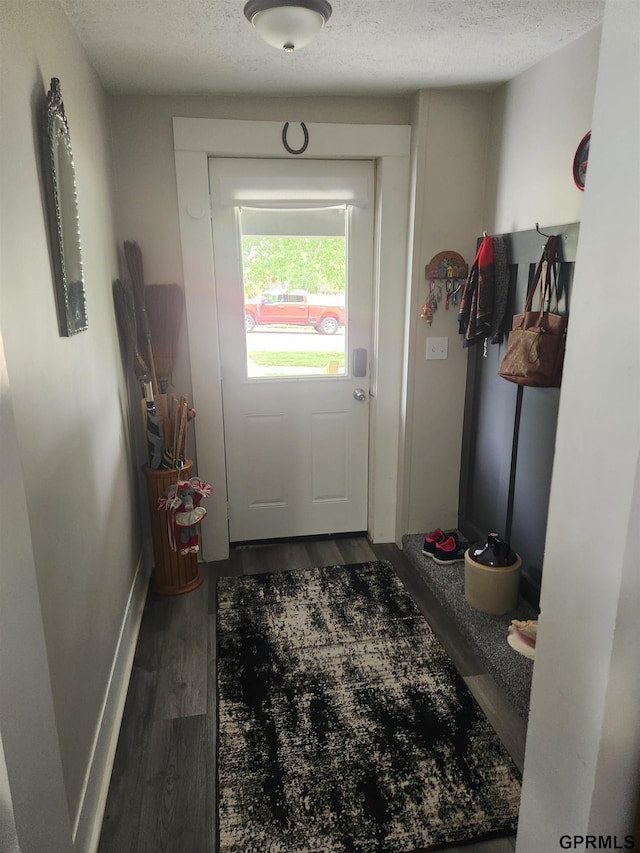 1211 D St, Fairbury, NE 68352 - entryway with a textured ceiling, wood finished floors, and baseboards