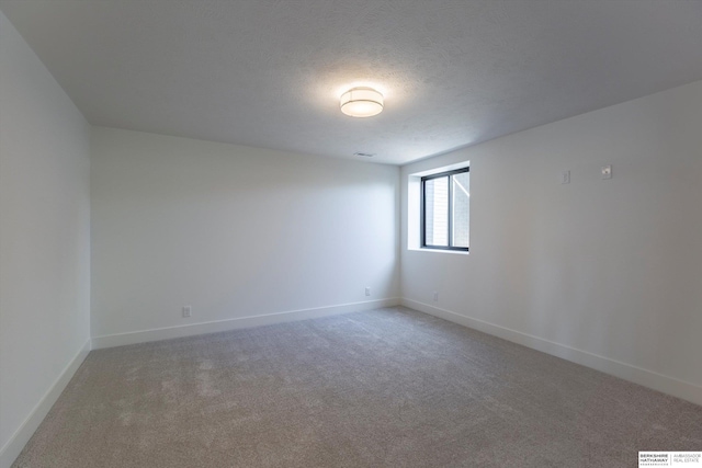 11019 N 166th St, Bennington, NE 68007 - unfurnished room with light colored carpet, baseboards, and a textured ceiling