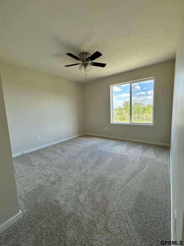 545 W Corsac Rd, Lincoln, NE 68523 - spare room featuring baseboards, carpet, and a ceiling fan