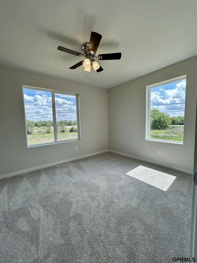 545 W Corsac Rd, Lincoln, NE 68523 - carpeted spare room featuring healthy amount of natural light, ceiling fan, and baseboards
