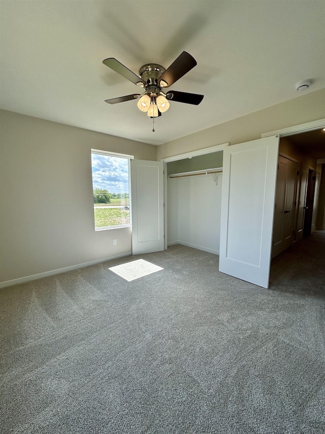 545 W Corsac Rd, Lincoln, NE 68523 - unfurnished bedroom with carpet floors, baseboards, ceiling fan, and a closet