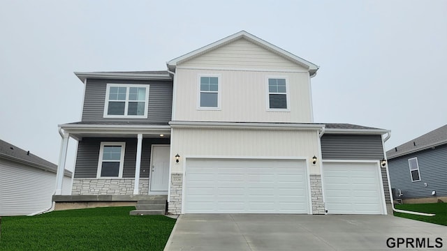 5412 N 188th St, Elkhorn, NE 68022 - traditional-style house featuring covered porch, stone siding, driveway, a front lawn, and a garage