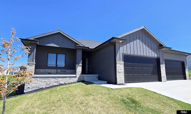 12003 S 109th St, Papillion, NE 68046 - view of front of house featuring a garage, board and batten siding, stone siding, a front lawn, and concrete driveway
