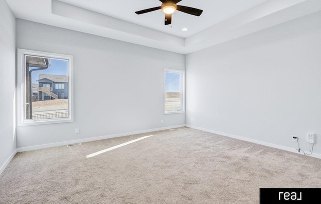 12003 S 109th St, Papillion, NE 68046 - spare room featuring baseboards, carpet floors, a ceiling fan, a tray ceiling, and recessed lighting
