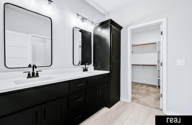 12003 S 109th St, Papillion, NE 68046 - full bathroom with double vanity, a walk in closet, and baseboards