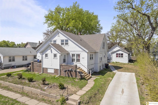 733 N H St, Fremont, NE 68025 - view of front of property with a shingled roof, a chimney, and a front lawn
