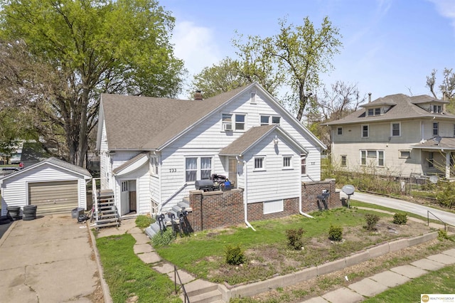 733 N H St, Fremont, NE 68025 - bungalow-style house with an outbuilding, driveway, a detached garage, and a shingled roof